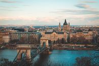 From above of old fashioned buildings located on river embankment near bridge in city